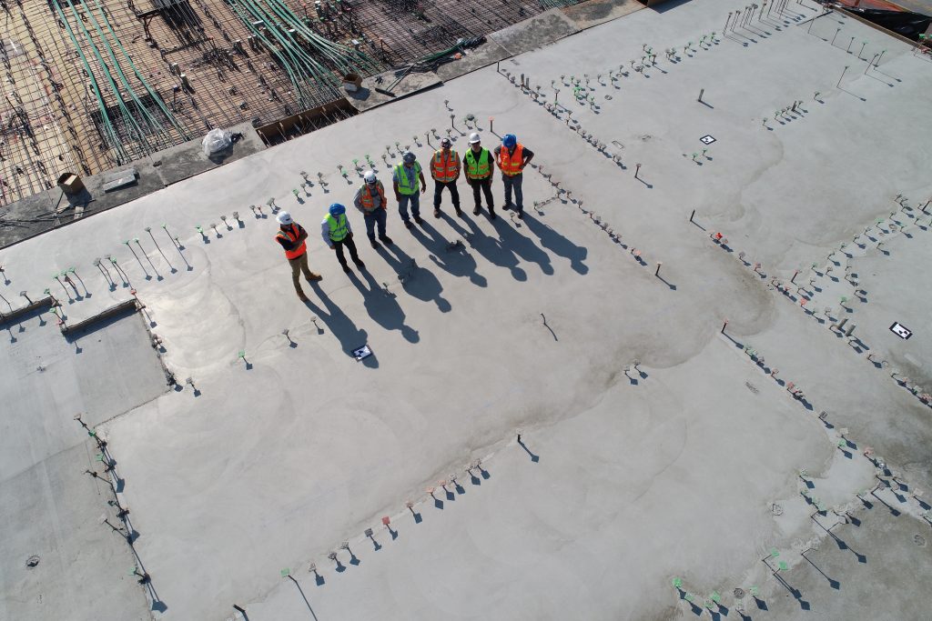 Vue aérienne d'un groupe d'ouvriers sur le toit d'un batîment en travaux